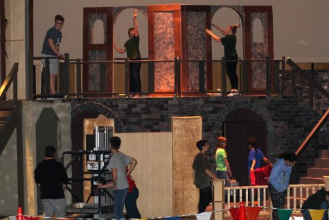 Cast and crew members work on their elaborate set pieces for the Les Miserables production. 