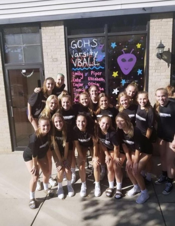 Volleyball team spends time together at the window painting event during their season.