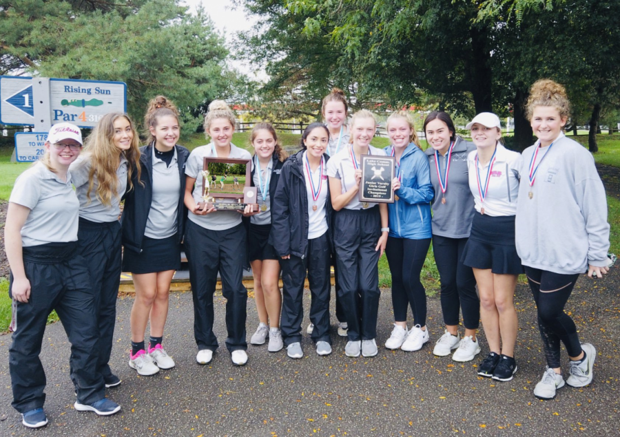 Girls Golf posing with the conference championship trophy.