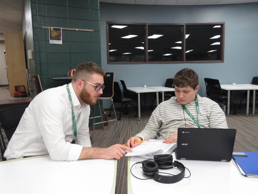 Teacher Cody Hatzer helping freshman Luciano Spaulding with math.