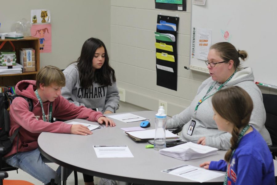 Leigh Cavanaugh helps students in their extra time through AIM. Photo by Caden Moe
