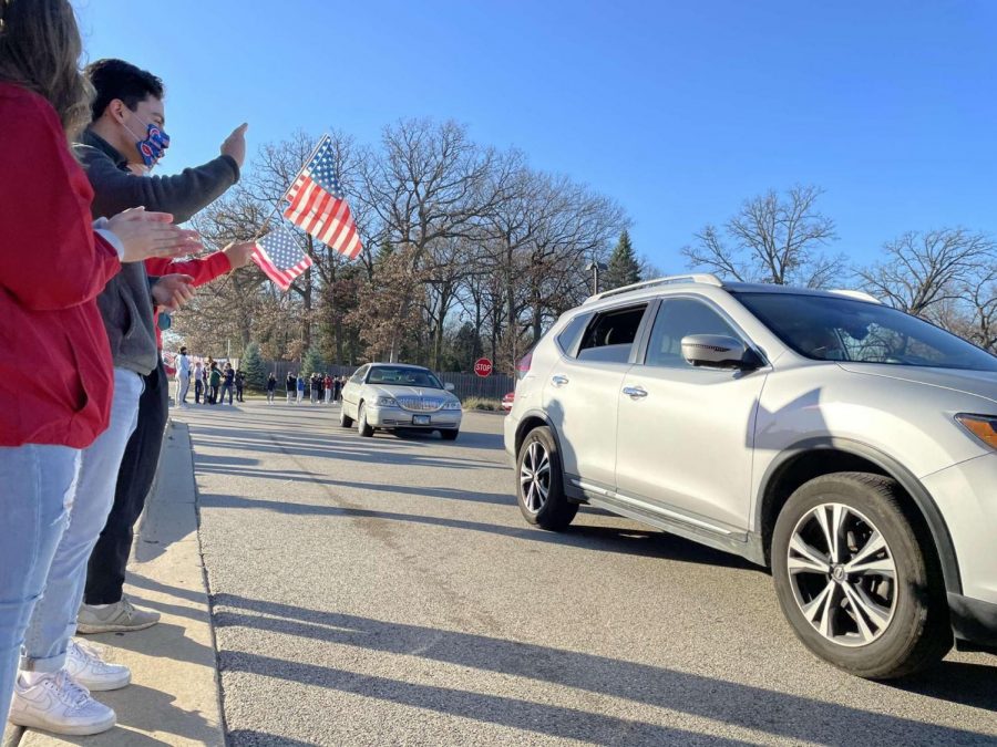 Students applaud and thank veterans as they drive by.
