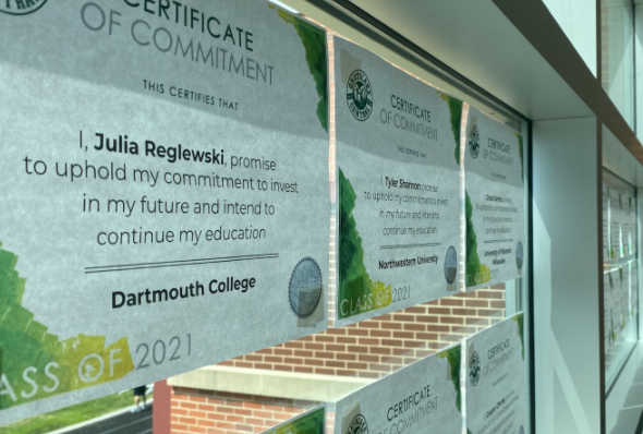 In the field house hallway, certificates of commitment are listed for seniors. The class of 2021 has been hard at work these past few months applying and getting ready to make a decision on their college of choice.