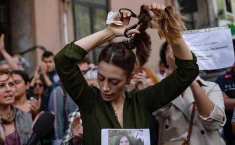 Nasibe Samsei, an Iranian woman, cuts her ponytail off during a protest