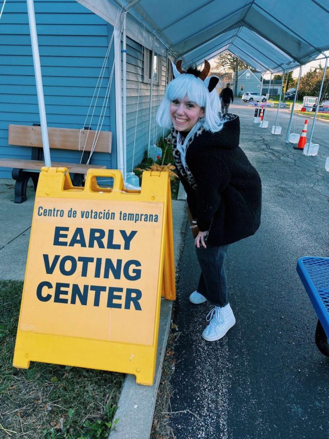 GCHS Senior Tori Whaples poses beside an early voting sign outside of a Grayslake polling location. Photo provided by Tori Whaples