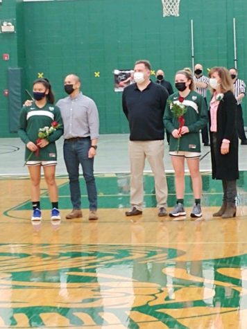 Drevline and Cave pose for a picture with their parents. Both seniors were greeted with  roses gifted from Coach Ikenn. Photo provided by Mk Drevline.