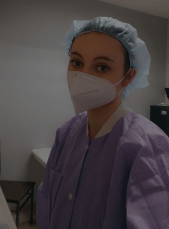 Student Rebecca Blumenberg dressed in full PPE takes a quick selfie while at work at GnG family dental care. Rebecca has been working there since June 2020 and loves her job. Rebecca would some day like to be a dental hygienist. Photo by Rebecca Blumenberg