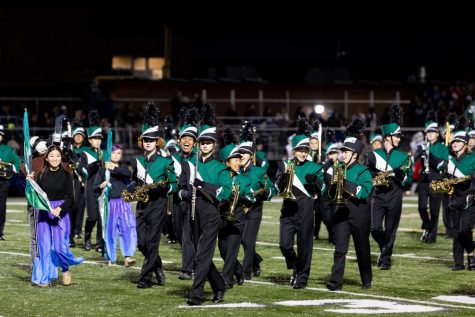 Band students happily walking off the field after a performance (Luis Torres)