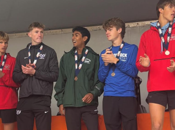 Adan Cordova celebrated earning All-State at IHSA State cross country meet on Nov. 8, 2025.