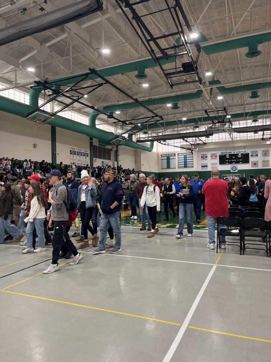 At the end of the Veteran's Day assembly,  students applaud the visiting veterans as they exit.
