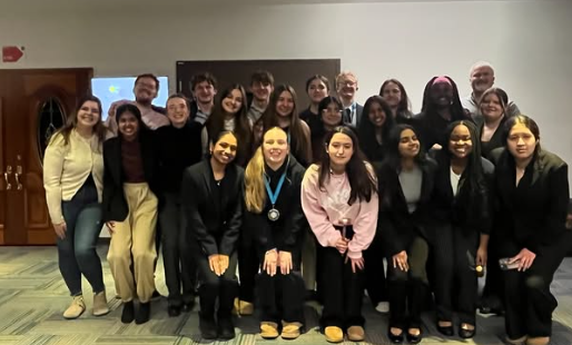 Debate students with Coach Edwards and Coach D'Amico pose in a team photo after the ICDA 6/ICDA State tournament on Feb. 21, 2026.