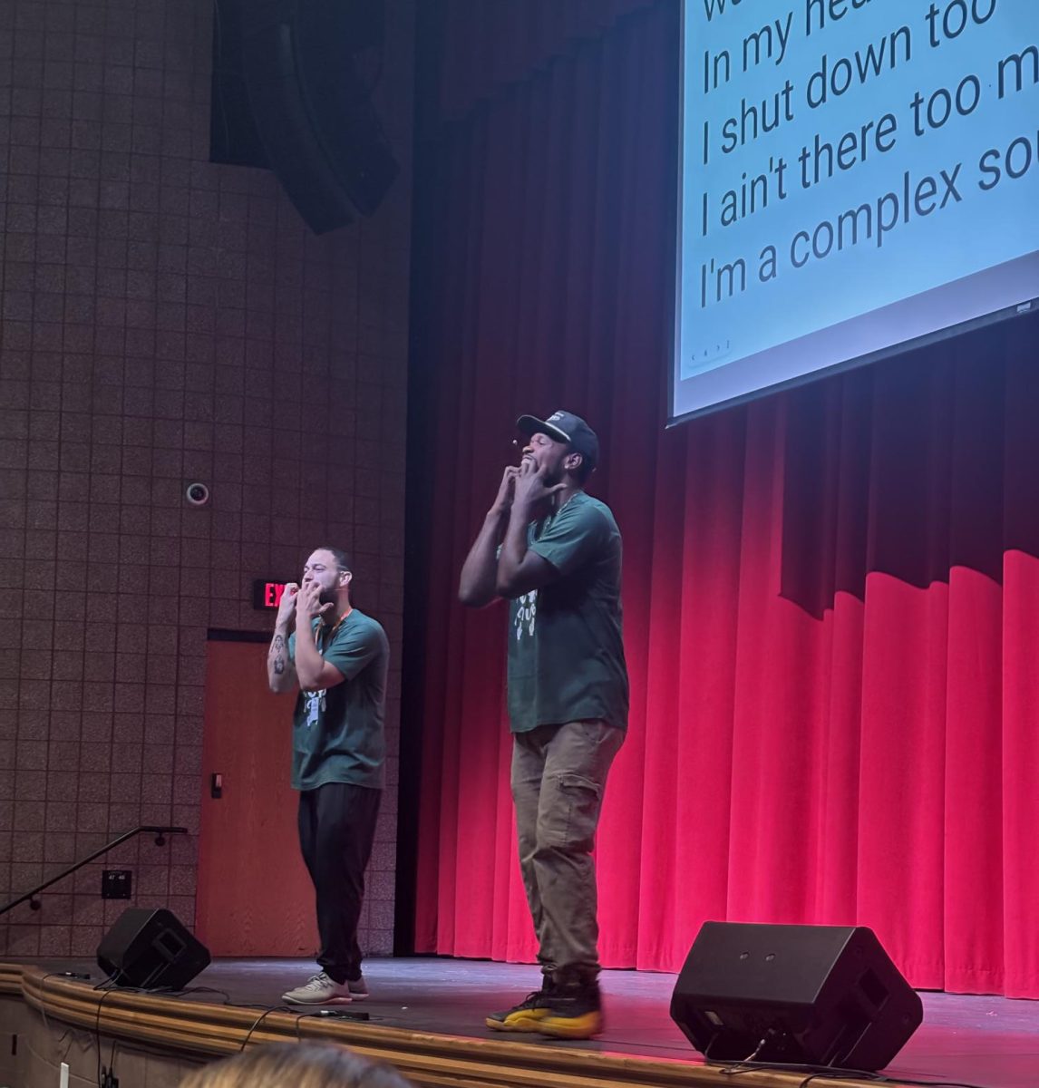 Julian Ortiz (left) and Matt Maxey (right) teach GCHS students ASL signs during Writers Week 2026.